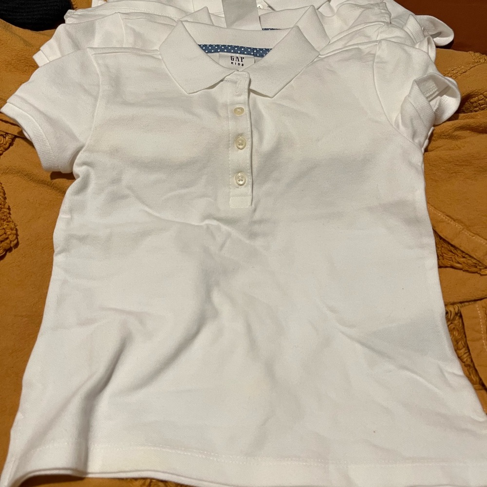 6 white uniform shirts. My daughter outgrew them bf she wore them